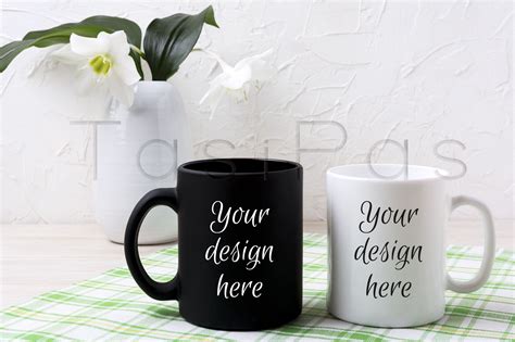 Download White and black mug mockup with lily in vase